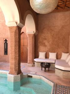 a room with a pool in the middle of a building at Riad Zahir in Marrakech