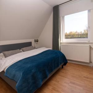 Кровать или кровати в номере Vakantiehuis Ochtendgloren