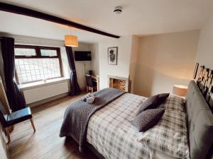 a bedroom with a large bed and a large window at The rushcart inn in Sowerby Bridge