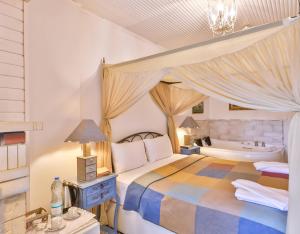 a bedroom with a bed and a tub and a sink at Park Mandalin Hotel - Adult only in Ağva