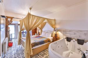 a master bedroom with a bed and a tub at Park Mandalin Hotel - Adult only in Ağva