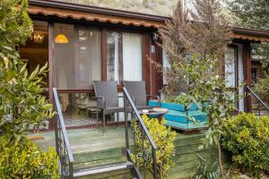 a porch of a house with chairs and a table at Park Mandalin Hotel - Adult only in Ağva