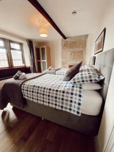 a bedroom with a bed and a dog on the bed at The rushcart inn in Sowerby Bridge