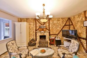 a living room with a stone wall with a fireplace at Park Mandalin Hotel - Adult only in Ağva