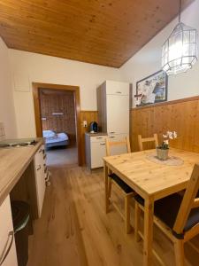 a kitchen and dining room with a wooden table at City-apart Kitzbühel in Kitzbühel