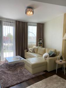 a living room with a couch and a coffee table at Vaszary Secret Nest in Balatonfüred