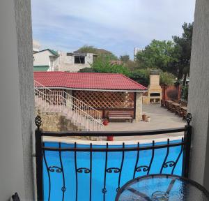 a balcony with a view of a building with a bench at Guest House Lima in Gelendzhik