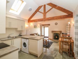a kitchen and living room with a washer and dryer at Shepherds Retreat in Ashbourne