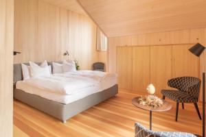 a bedroom with a bed and a table and chairs at Hotel Gasthaus Hergiswald in Eigenthal