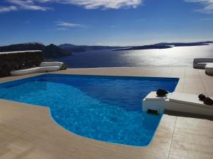 a swimming pool with a view of the water at Aegean Blue Icons in Foinikiá