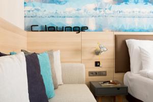 a room with a bed and a couch and a table at Sunprime C-Lounge - Adult Only in Alanya