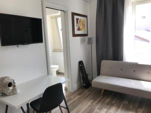 a living room with a white table and a couch at La Dimora delle Muse in Catania