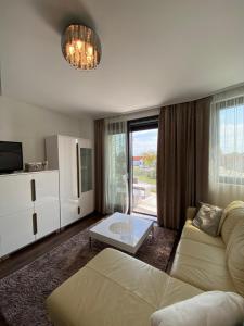a living room with a couch and a table at Vaszary Secret Nest in Balatonfüred