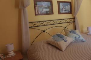 a bedroom with a bed with two pillows on it at Affittacamere Il Veliero in Duino