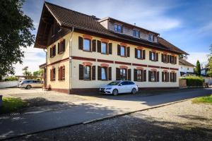 a white car parked in front of a building at Sonniges Familien-Nest im Allgäu in Hergatz