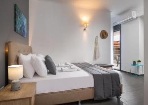 a bedroom with a large bed with white pillows at Eolica Rooms in Sarti