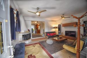 a living room with a couch and a fireplace at Maisonette Ilios in Plisioí