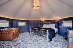 a bedroom with a bed and a couch in a room at Enterkine Country House Resort in Annbank +51 photos