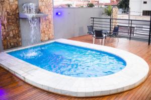 a large swimming pool with a fountain in a building at Vivendas Rio Claro by Atlantica in Rio Claro