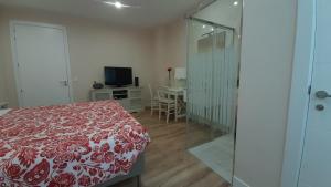 a bedroom with a red and white bed and a television at Guggenheim Bilbao Center in Bilbao