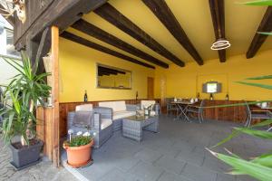 a patio with a couch and chairs and a table at Landgasthof zur Sonne in Auggen