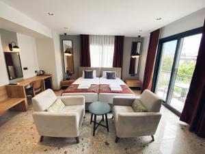 a hotel room with a bed and a table and chairs at Avilia Suites in Fethiye