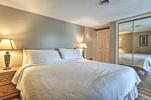 a bedroom with a large bed and a mirror at Riverside Condo 2 Miles to Smoky Mtns Ntl Park! in Townsend