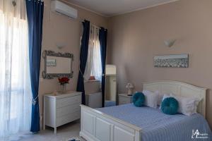 a bedroom with a bed and a dresser and a mirror at M&A in Casamassima