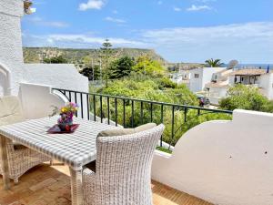 a table and chairs on a balcony with a view at Vila Vista Luz in Lagos