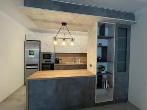 a kitchen with a counter top and a refrigerator at CENTRAL Lux Apartment in Varna City