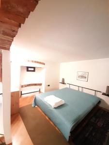 a bedroom with a bed in a white room at Lerici Home in Lerici