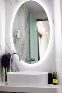 a bathroom with a sink and a mirror at Elsa Exclusive Double Sea View - Adults Only in Plakias