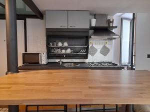 a kitchen with a wooden table in a kitchen at Lerici Home in Lerici
