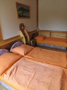 a room with two beds and a stuffed animal in it at Tüttös vendéghàz in Hedrehely