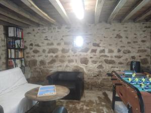 a room with a bed and a table with a chessboard at KERFLAVEUR in La Fresnaye-au-Sauvage
