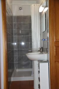 a bathroom with a sink and a shower and a sink at Le moulin Bertrand in Martigny-Courpierre +28 photos