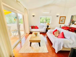 a living room with a white couch and a table at Vila Vista Luz in Lagos