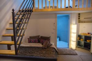 a living room with a couch under a staircase at Ice guest house in Majdal Shams