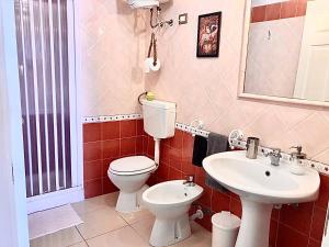 a bathroom with a toilet and a sink at Marina Design Apartment in Marina di Ragusa +22 photos