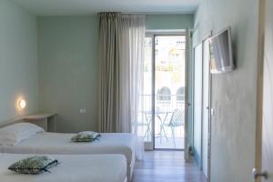 Postel nebo postele na pokoji v ubytování Aromi Piccolo Hotel