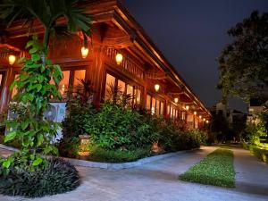 a building with a lot of plants and lights at Tam Coc La Montagne Resort & Spa Ninh Binh in Ninh Binh