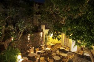 an outdoor patio with tables and chairs at night at Elpida Village in Istro