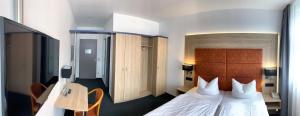 Postel nebo postele na pokoji v ubytování Median Hotel Garni