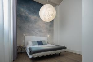 A bed or beds in a room at Fornace Loft with Dependance R&R