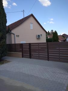 a fence in front of a house at Otthon Apartman in Hajdúszoboszló