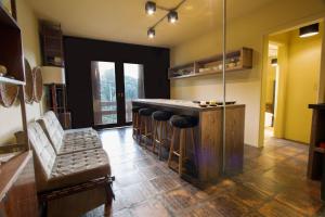 a kitchen with a bar with a bar stools at Bela Vista 201 - My Home Temporada in Gramado