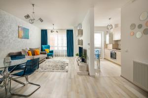 a living room with a couch and a table at Brasov Holiday Apartments in Braşov