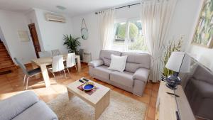 a living room with a couch and a table at Villa Cerezo - A Murcia Holiday Rentals Property in Torre-Pacheco