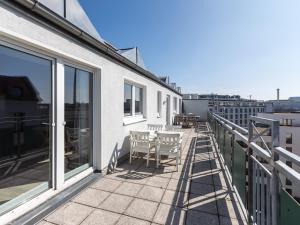 a balcony with a table and chairs on it at Limehome Berlin Chausseestraße in Berlin