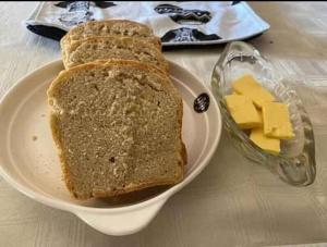 a plate with a sandwich and cheese on a table at Hollywood Lodge in Steinkopf